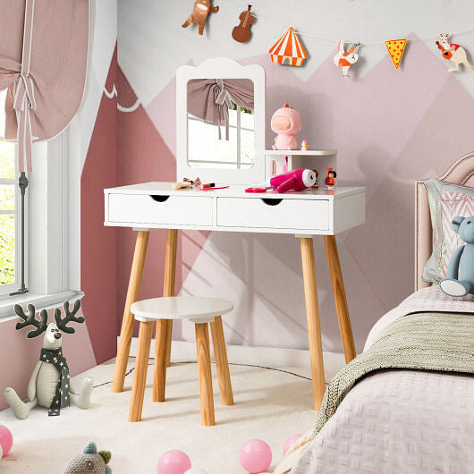 Children's room with a white vanity table, mirror, and stool against a pink wall.