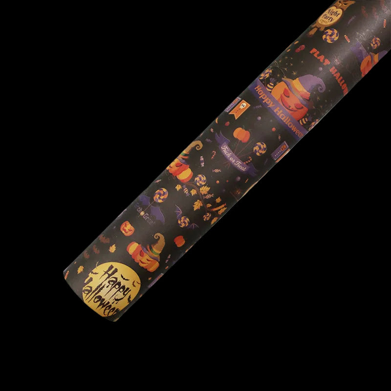 Roll of Halloween-themed wrapping paper with pumpkins and ghosts on a white background