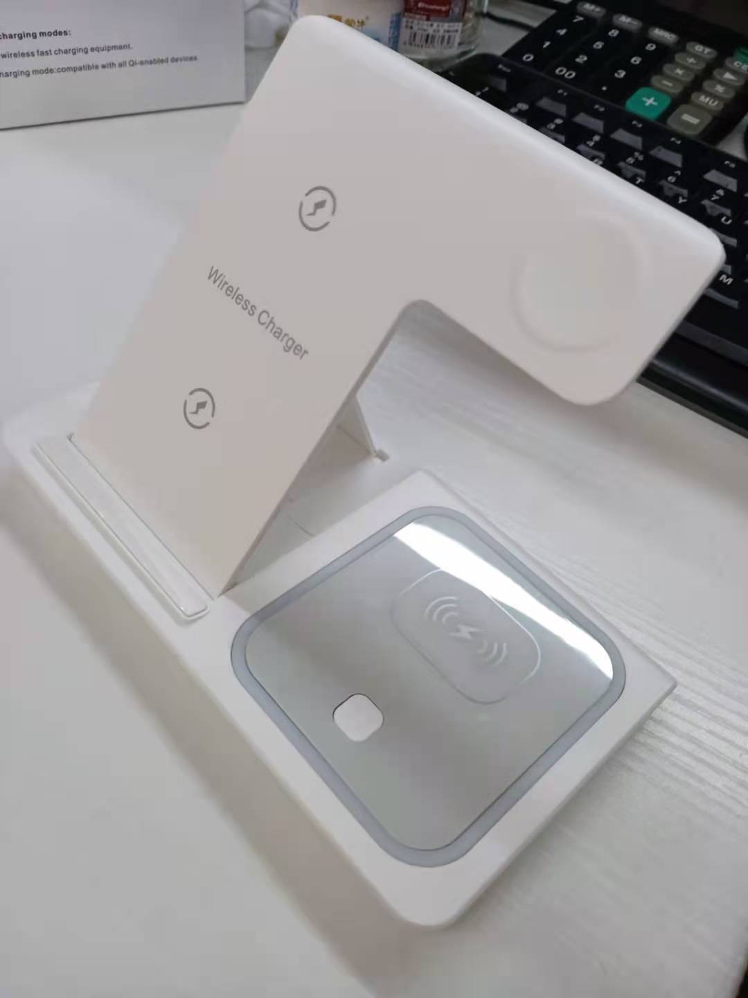 Wireless charger on a desk with a keyboard in the background