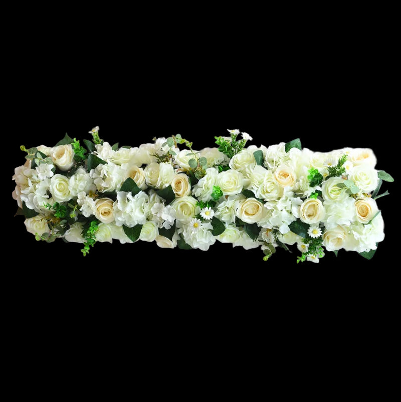Floral arrangement with white and yellow flowers on a light pink background