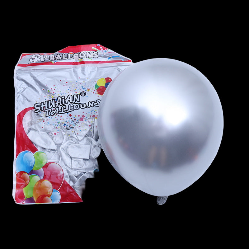 Silver balloon next to its packaging on a white background