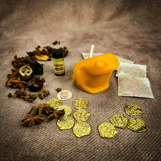 Spices, gold coins, a bottle, and other items on a textured surface