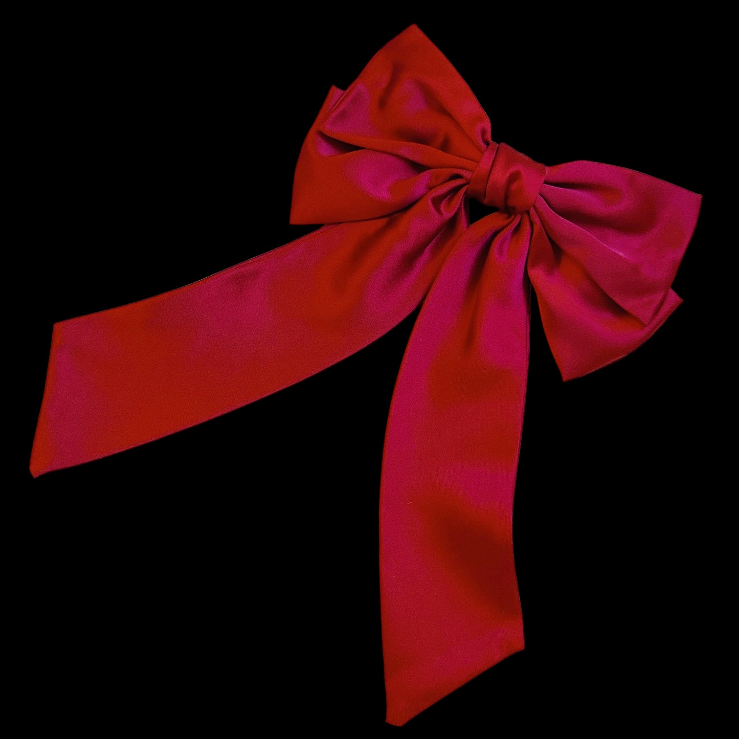 Red satin bow on a light gray background