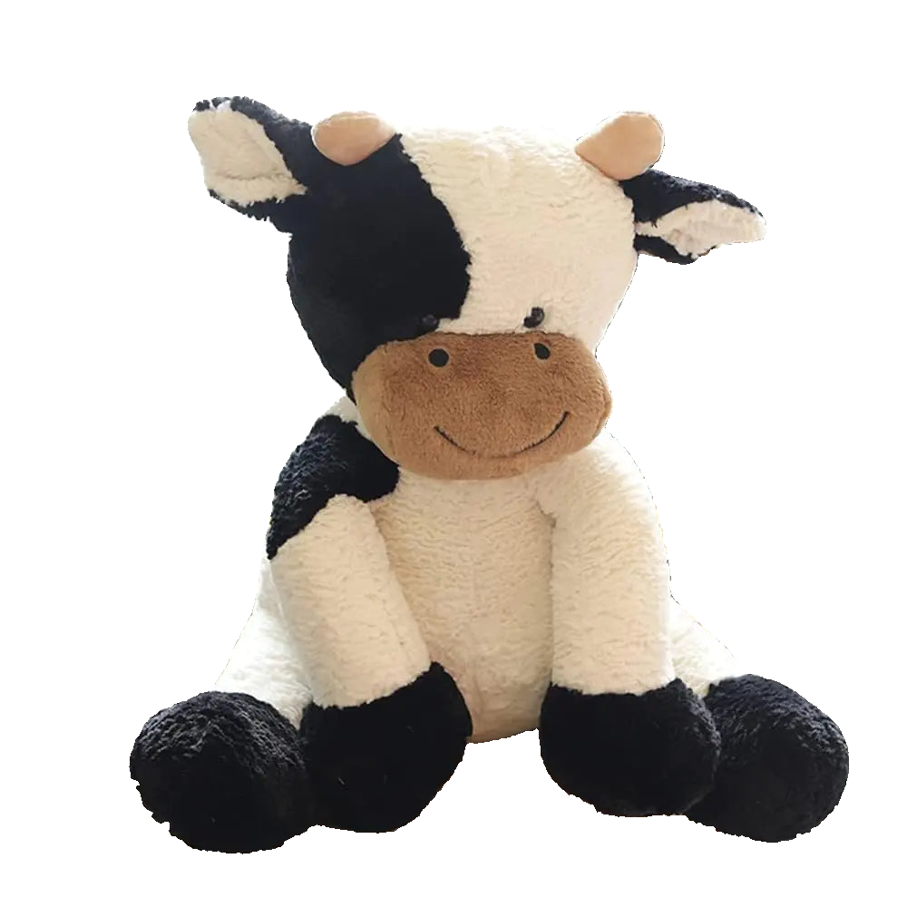 Plush cow toy sitting on a chair with a blurred indoor background