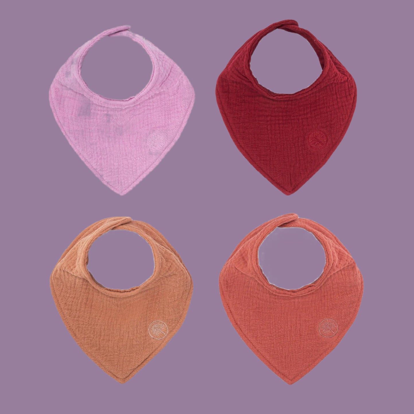 Four baby bibs in pink, red, and brown on a white background