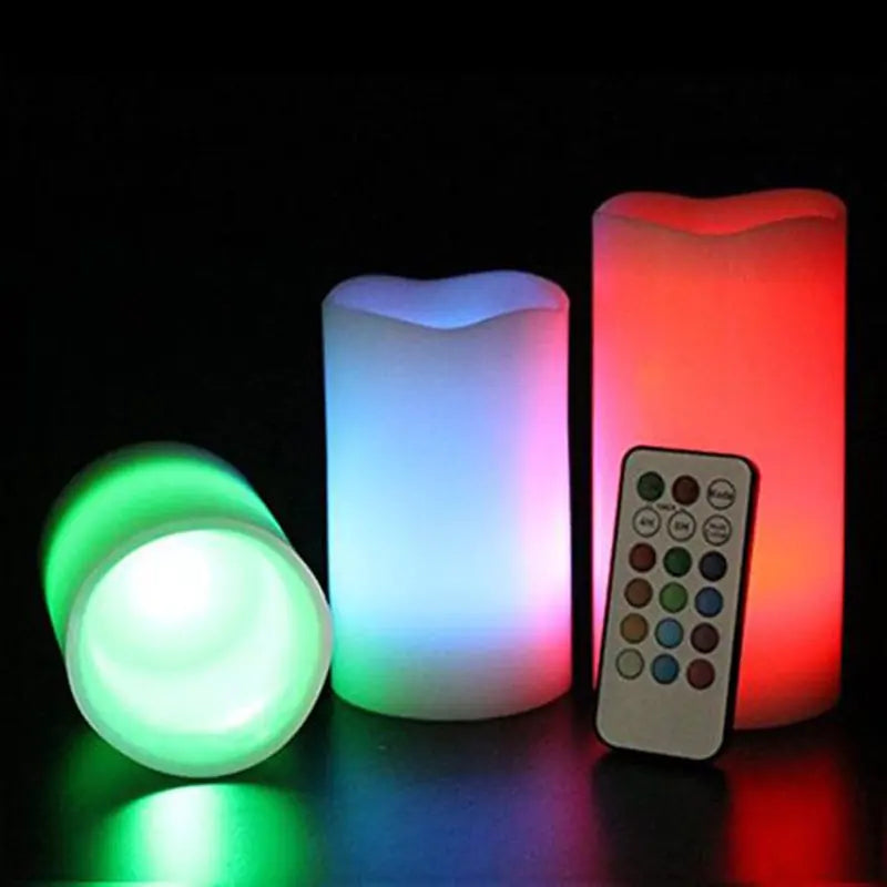 Set of colorful LED candles with a remote control on a dark background