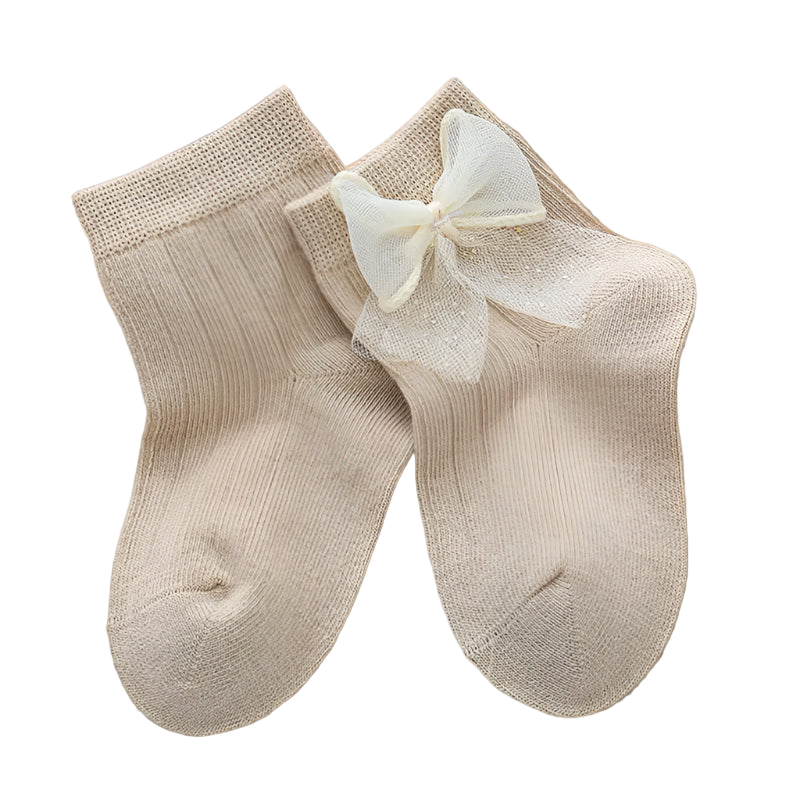 Beige socks with a bow on a light background