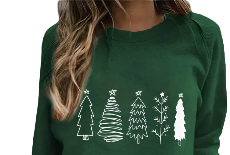 Green sweatshirt with white Christmas tree designs worn by a person, holding flowers.