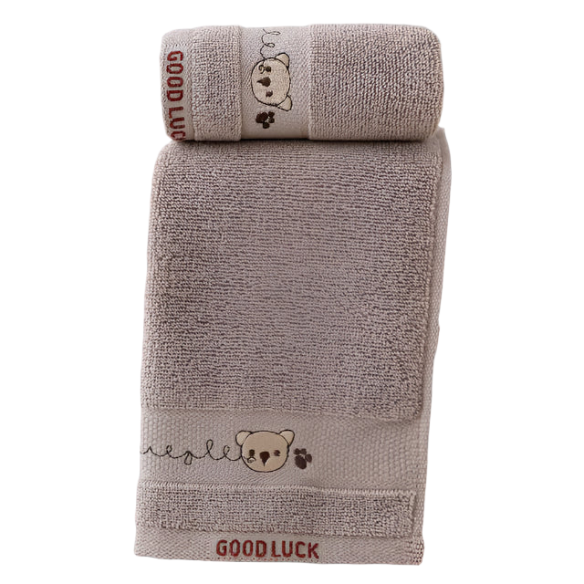 Two brown towels with teddy bear designs and 'Good Luck' text on a white background.