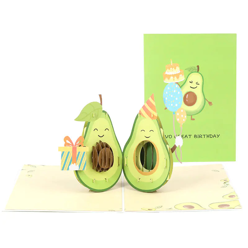 Avocado-themed pop-up card with a smiling avocado and a birthday card in the background.