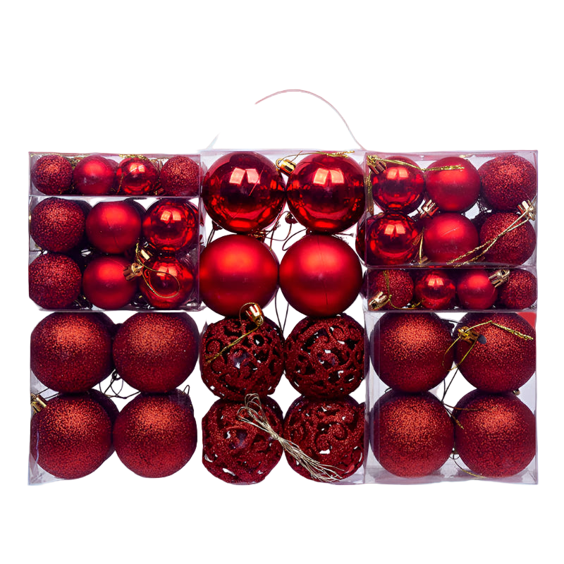 Assorted red Christmas ornaments in a clear box on a white background