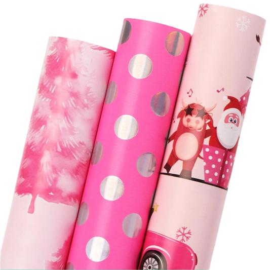 Three rolls of pink gift wrap paper with different designs on a white background