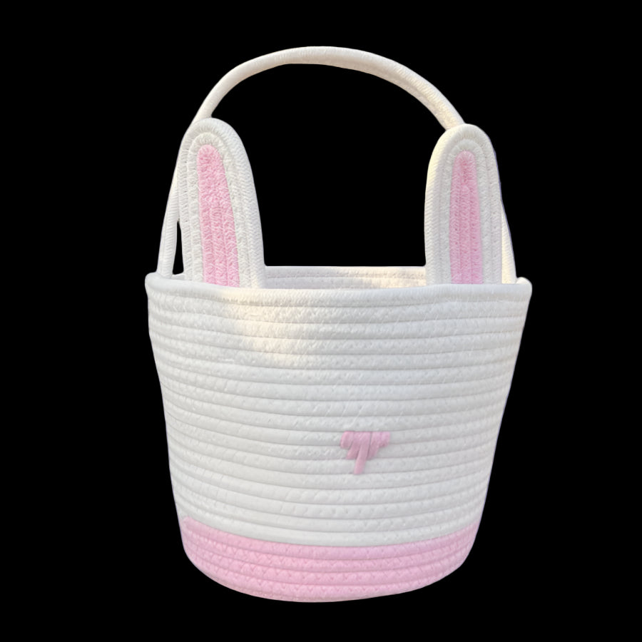 White woven basket with pink accents on a white background