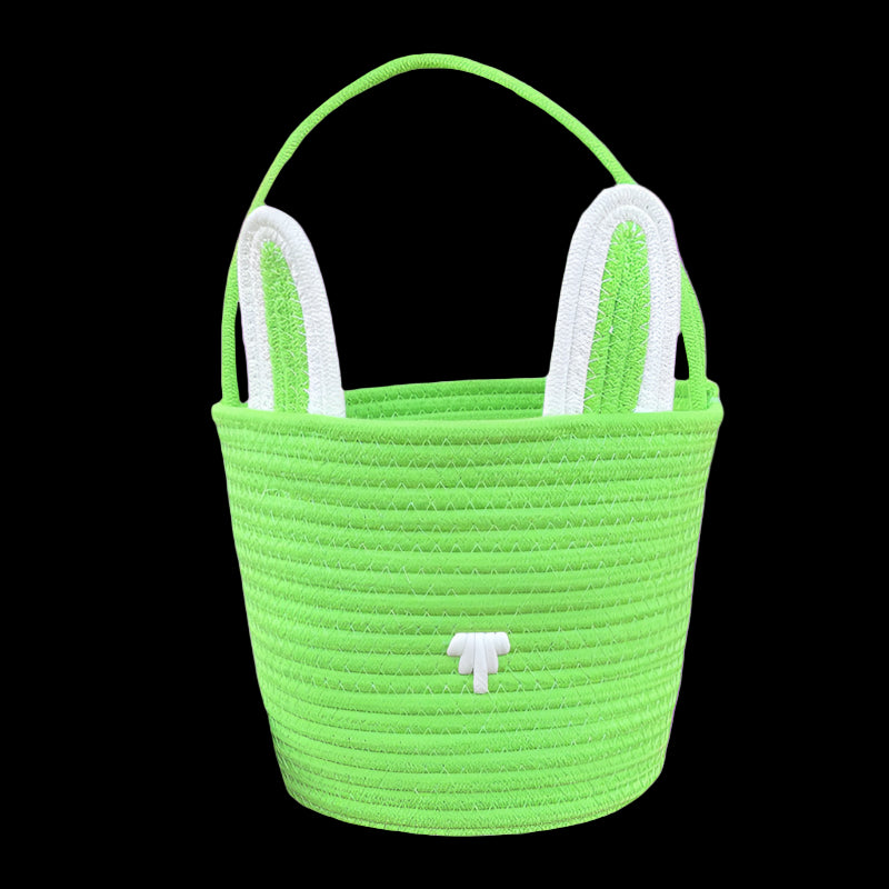Green woven basket with white handles on a white background