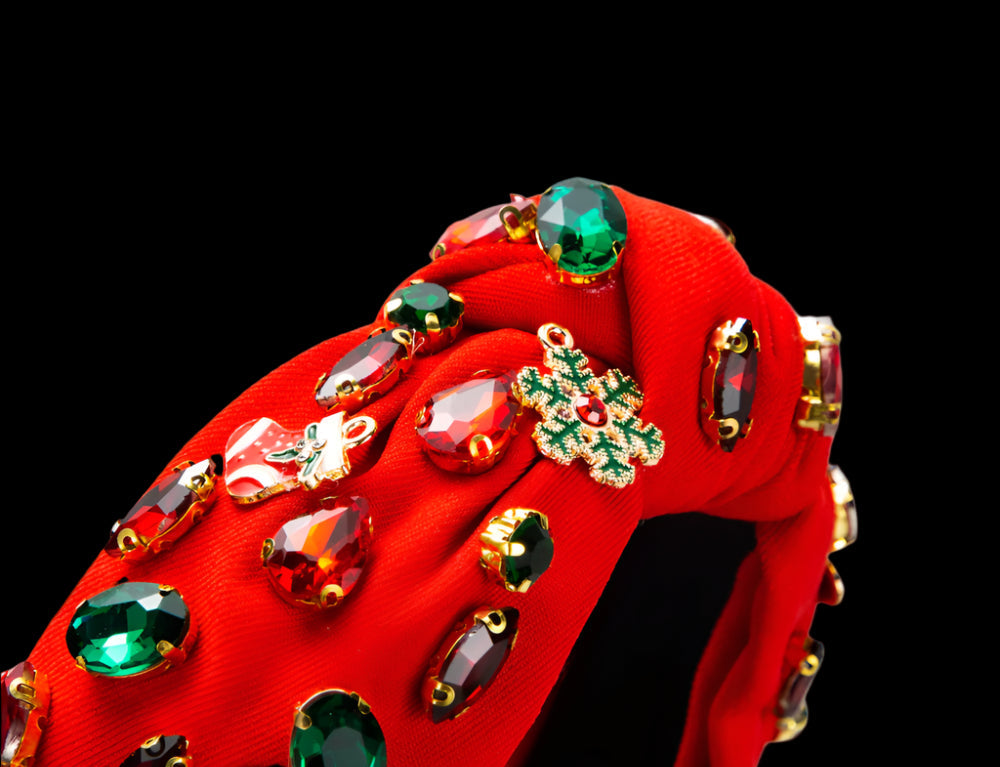 Red shoe with gemstone embellishments on a white background