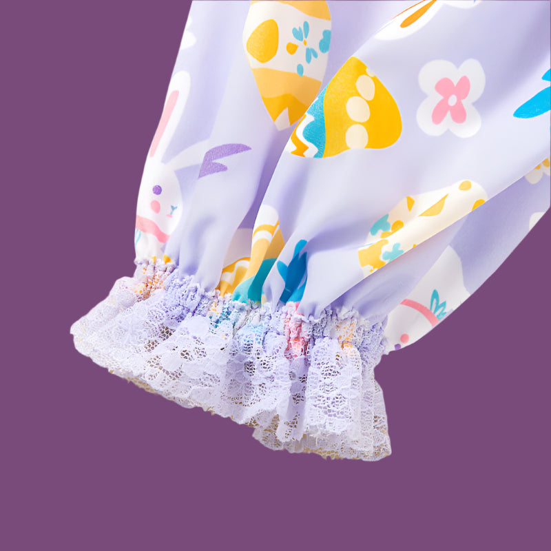 Colorful children's dress with floral and animal patterns on a beige background