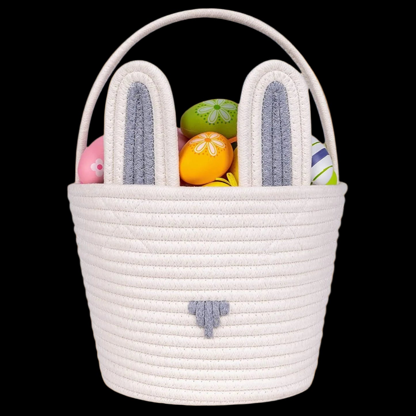 White woven Easter basket with bunny ears filled with colorful eggs on a white background