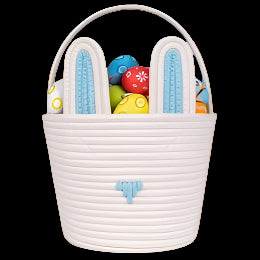 White woven Easter basket with bunny ears filled with colorful toys on a white background