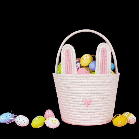 White woven Easter basket with colorful eggs on a pink background