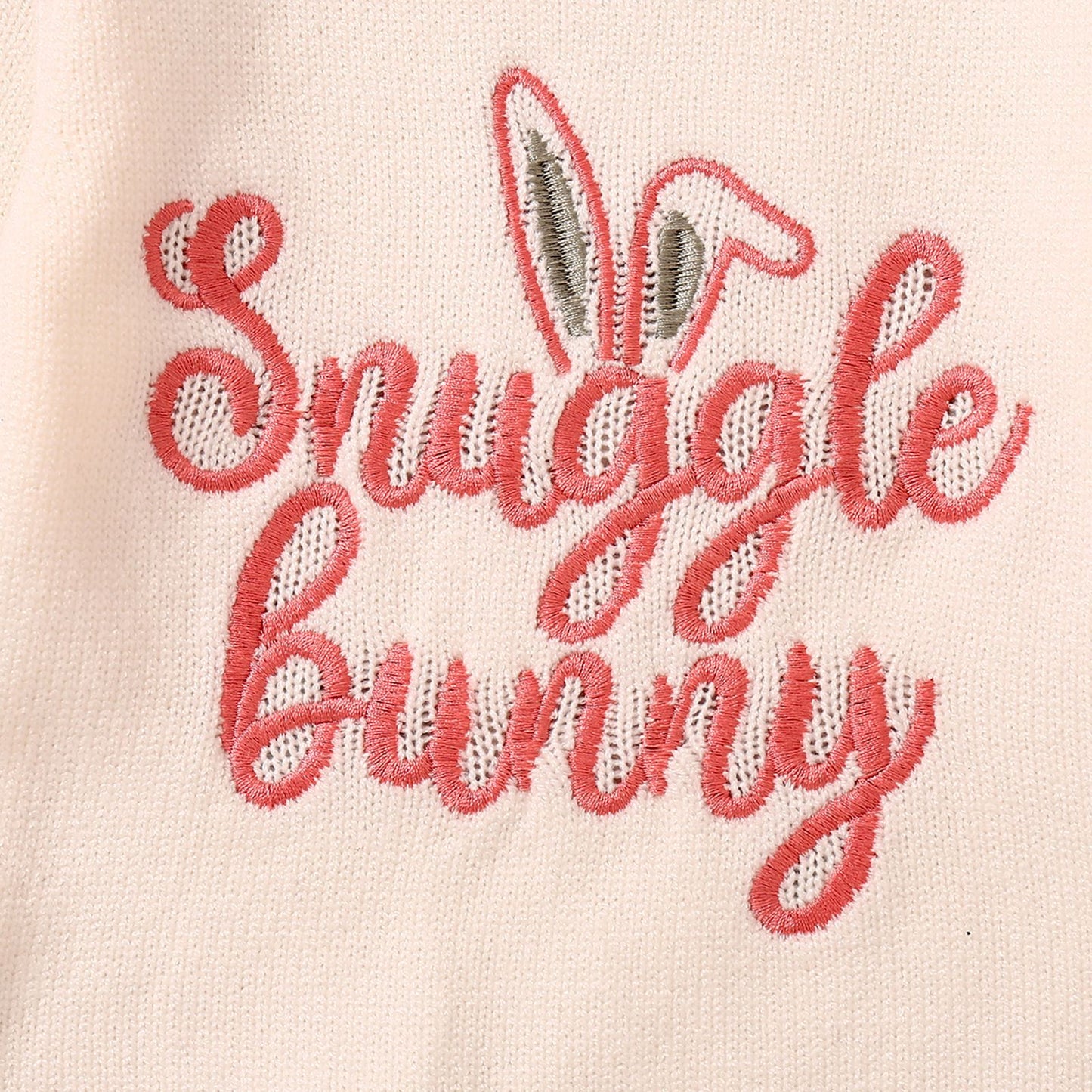 Embroidered text 'Snuggle Bunny' on a light pink background