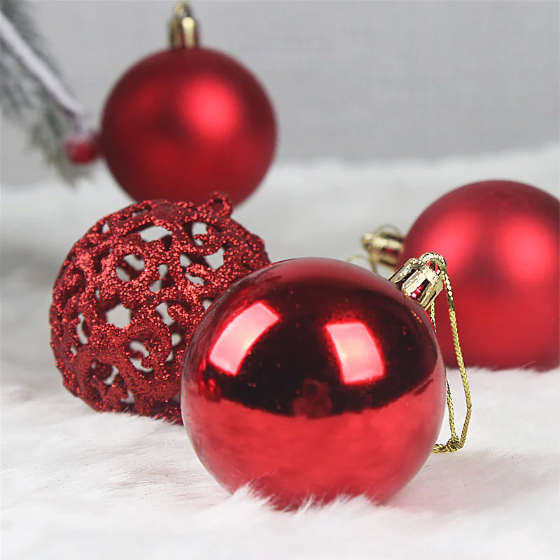 Red Christmas ornaments on a white surface