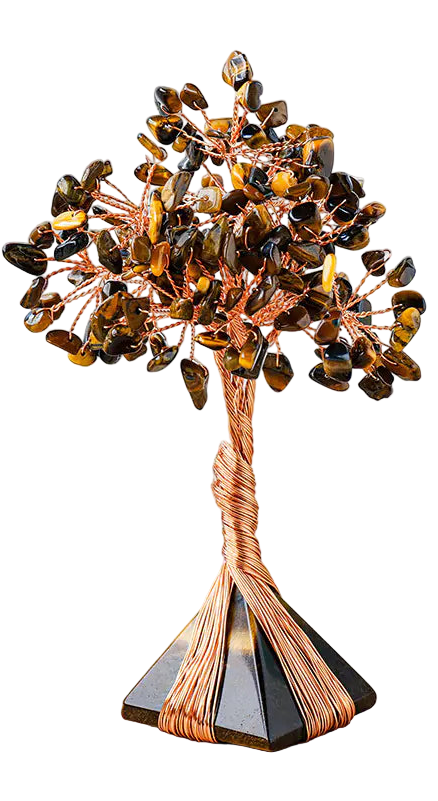 Decorative crystal tree on a wooden surface with a white background