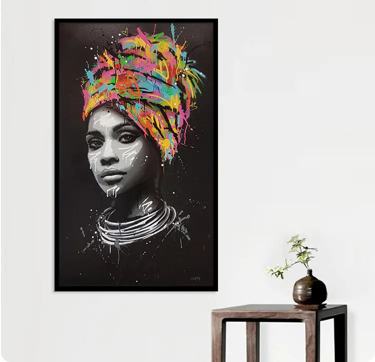 Framed artwork of a woman with a colorful headscarf on a white wall.