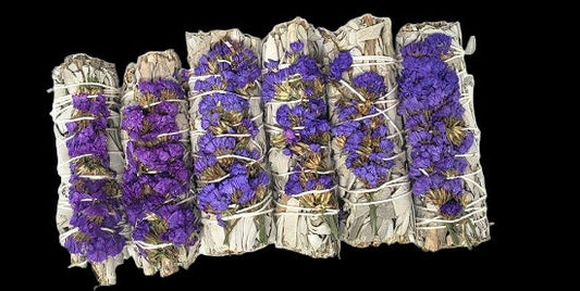 Five bundles of smudge sticks with purple flowers on a white background