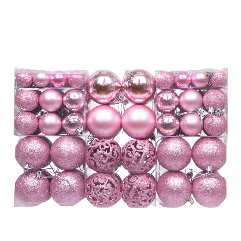 Assorted pink Christmas ornaments in a clear box on a white background