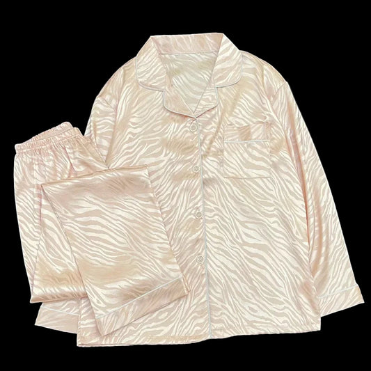 Light pink pajama set with wavy pattern on a black background