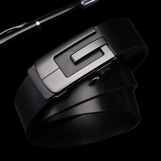 Black leather belt with silver buckle on a dark surface, pen to the side.