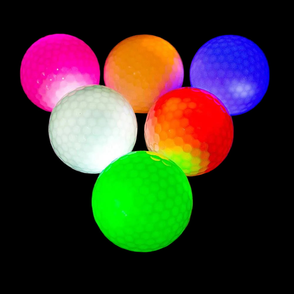 Colorful golf balls glowing in the dark on a reflective surface.