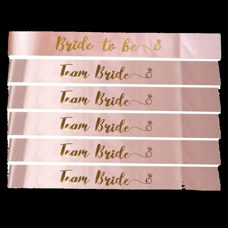 Set of pink sashes with 'Team Bride' and 'Bride to Be' text on a white background