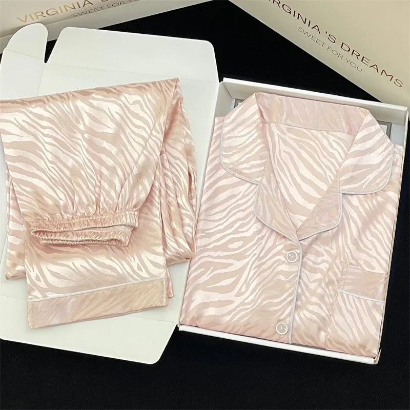 Pink pajama set with zebra pattern on a white box, branded 'Virginia's Dreams'.