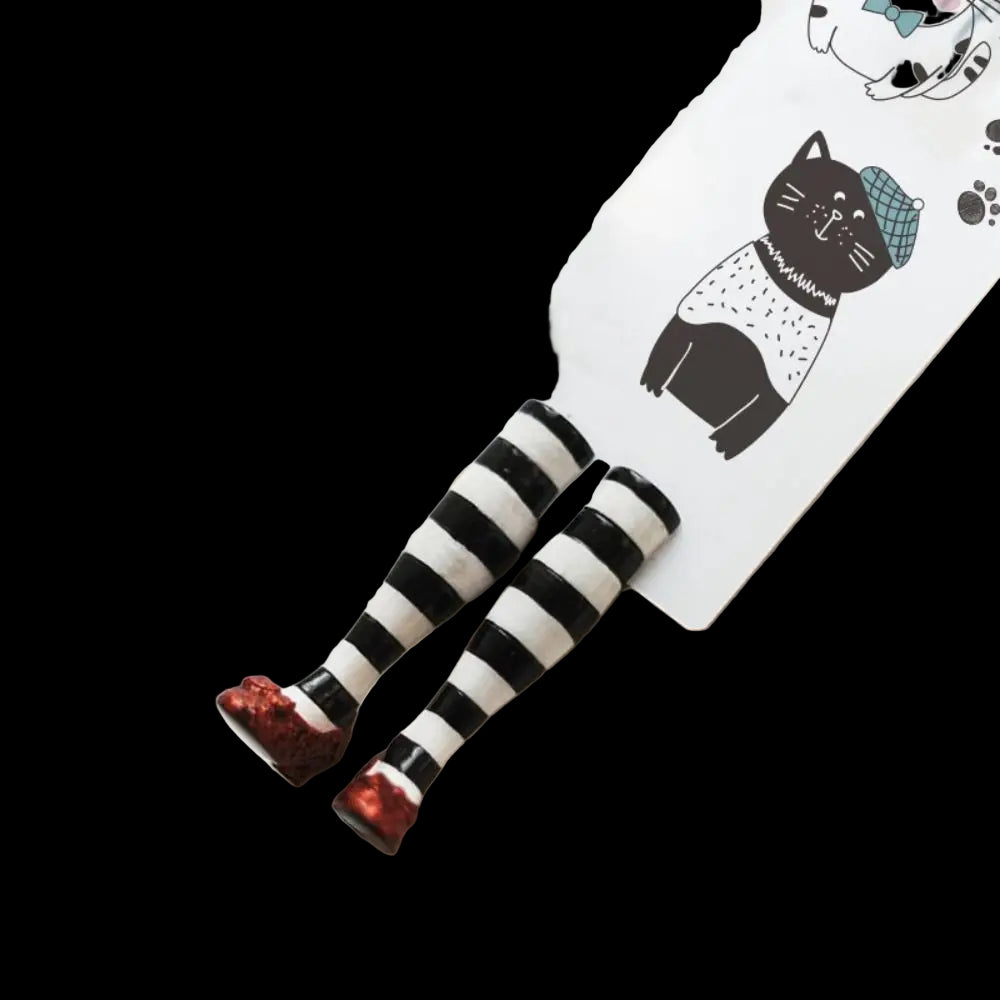 Black and white striped hair clips with red paws on a white background