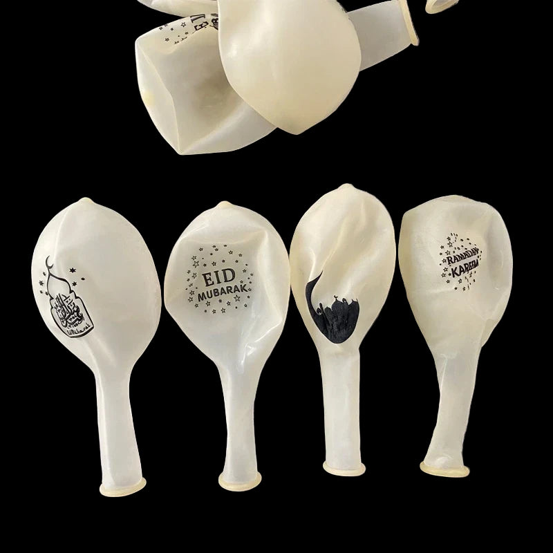 White balloons with black text and designs on a gray surface