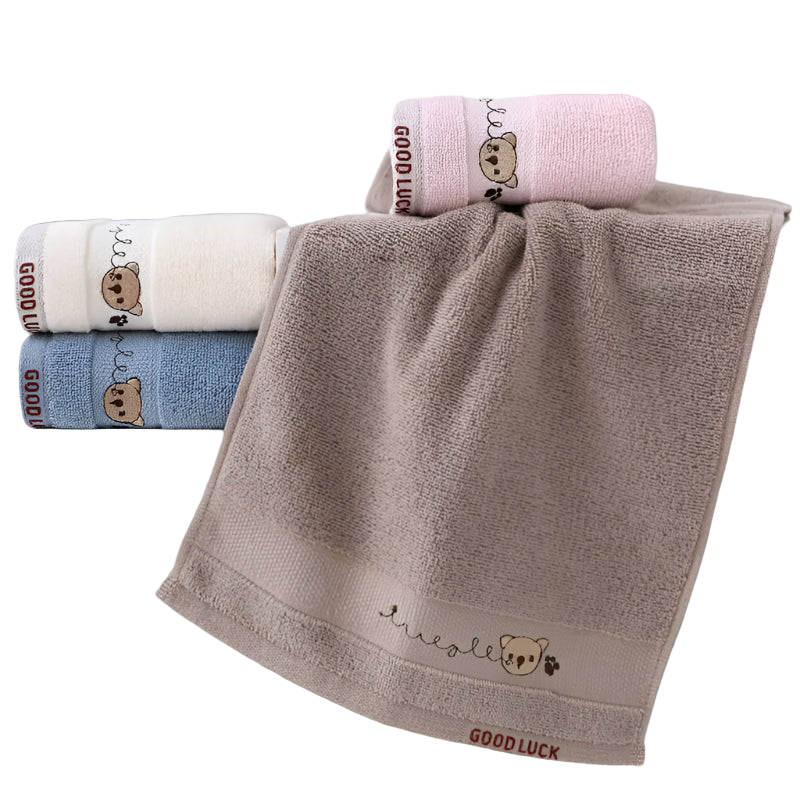 Set of embroidered towels with cartoon bear design on a white background