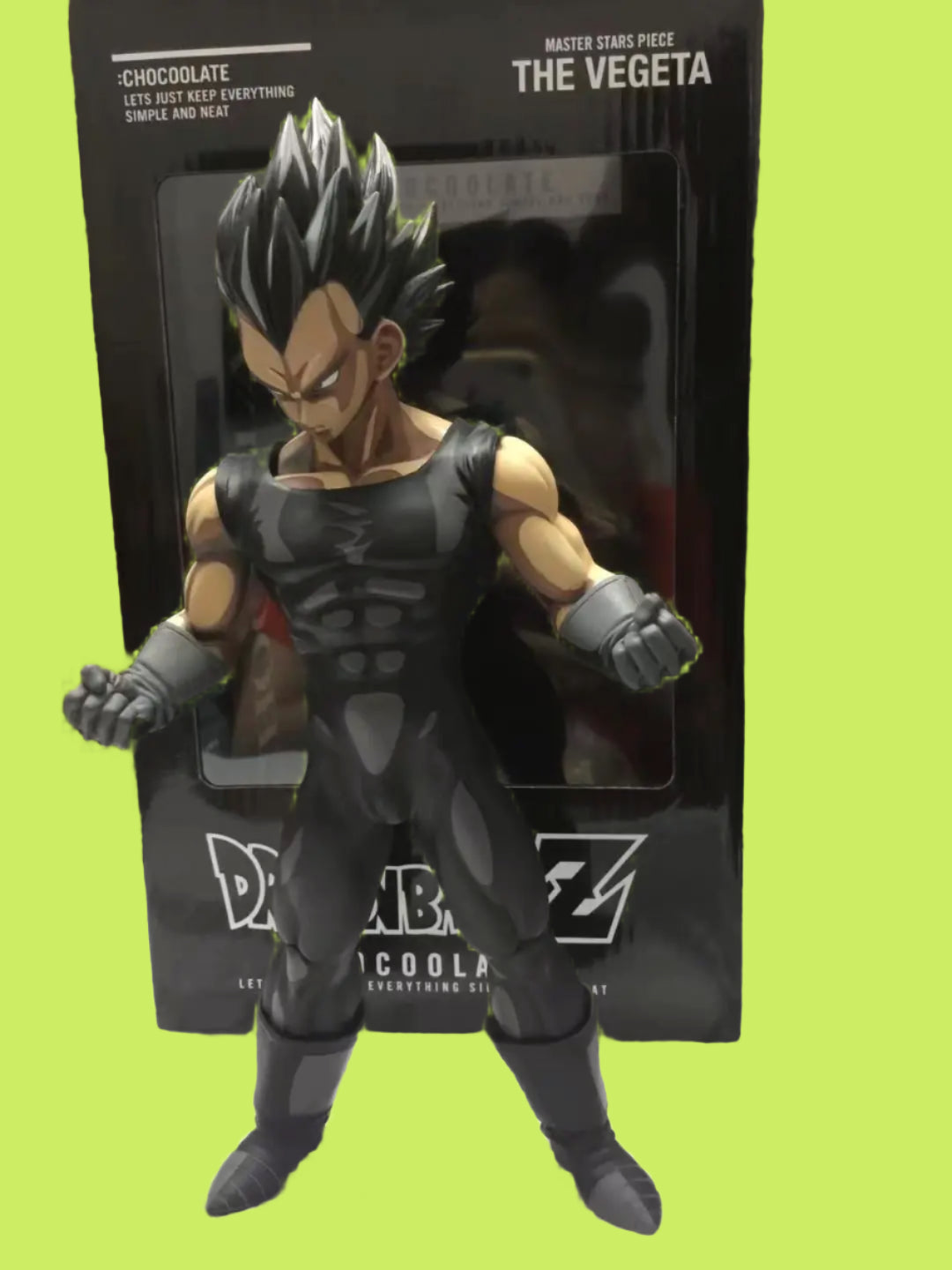 Action figure of a character in a black and gray outfit with packaging in the background