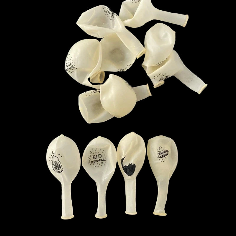 White balloons with printed designs on a gray surface