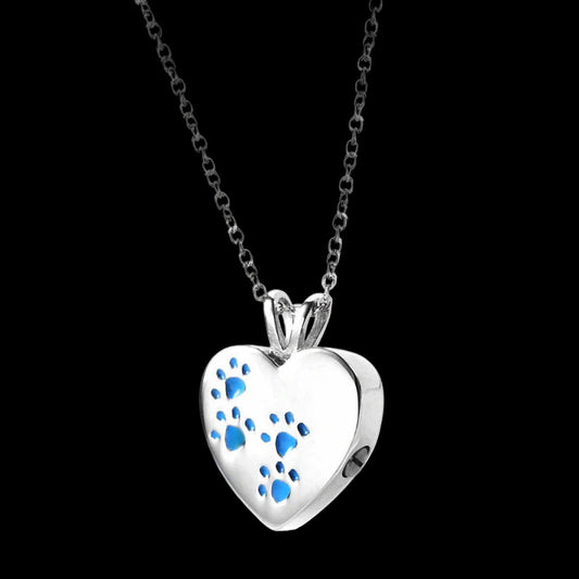 Heart-shaped pendant with blue paw prints on a white background