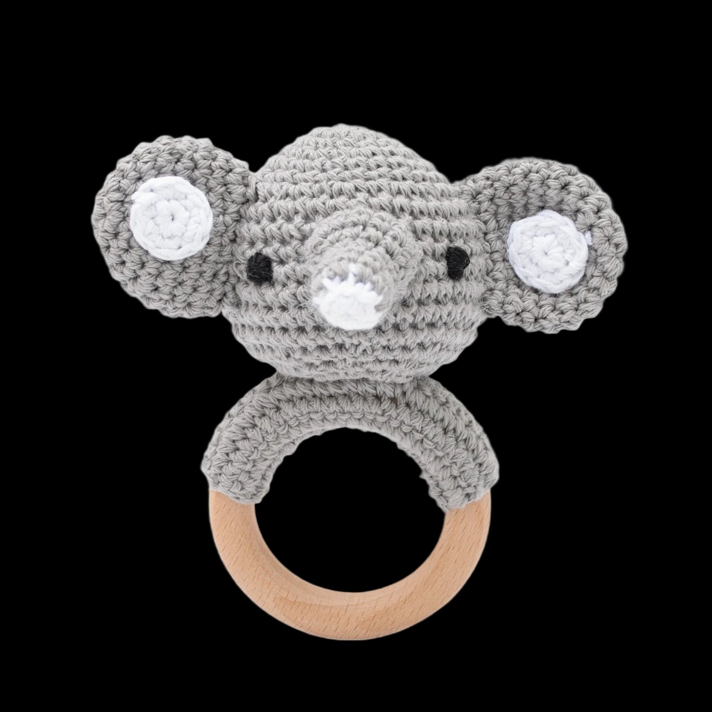 Crocheted koala rattle with a wooden ring on a white background