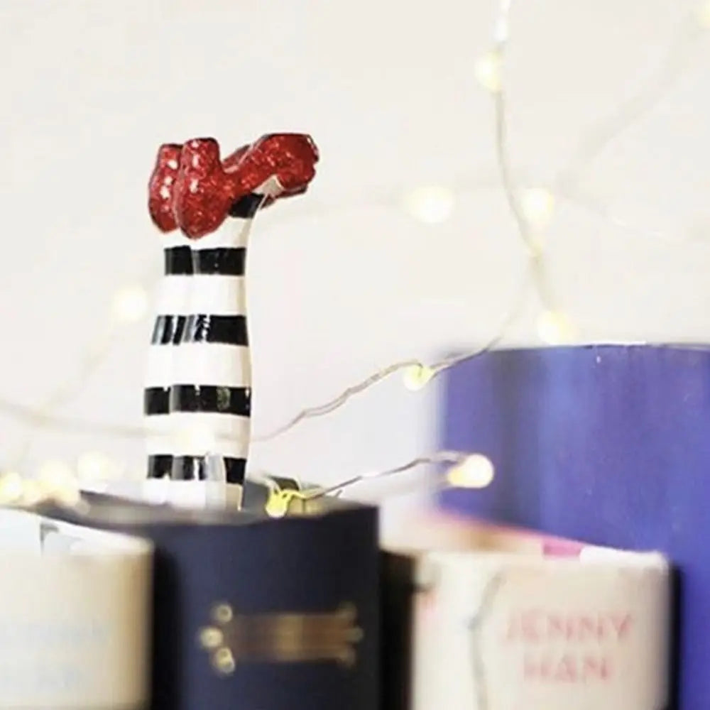 Decorative boot with red top and black and white striped pattern on a blurred background