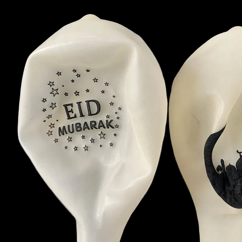 White ceramic spoon with 'EID MUBARAK' text on a gray background