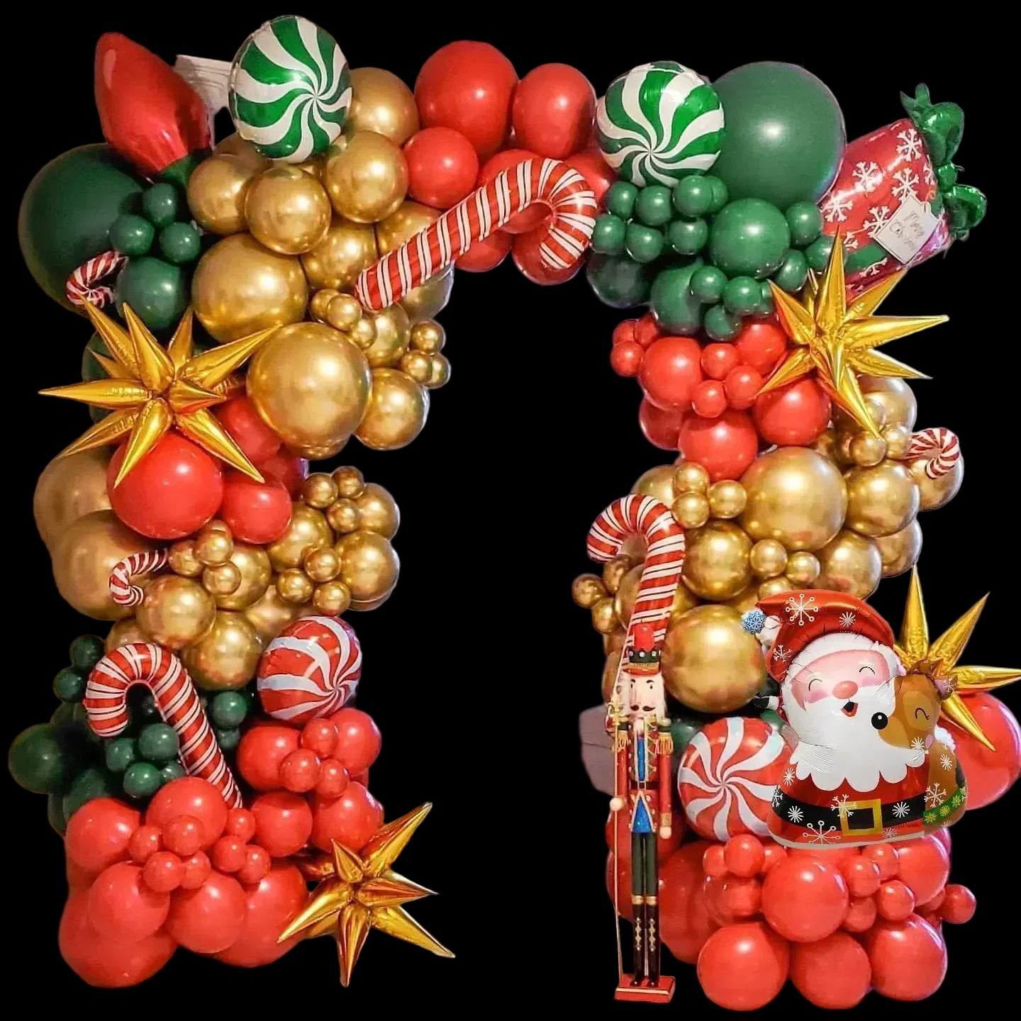 Decorative balloon arch with Christmas-themed balloons, including Santa Claus and candy canes.