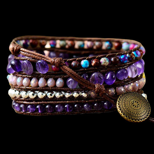 Multistrand beaded bracelet with a decorative button on a wooden surface