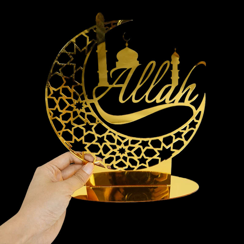 Decorative metal art piece with 'Allah' on a crescent moon design, held by a hand.