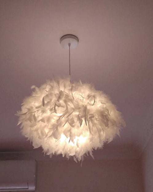 Fluffy white ceiling light fixture in a room with air conditioner and window.