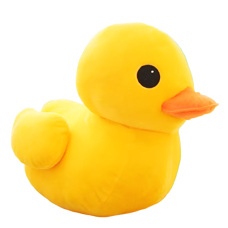 Yellow plush duck toy on a wooden surface with a light-colored background