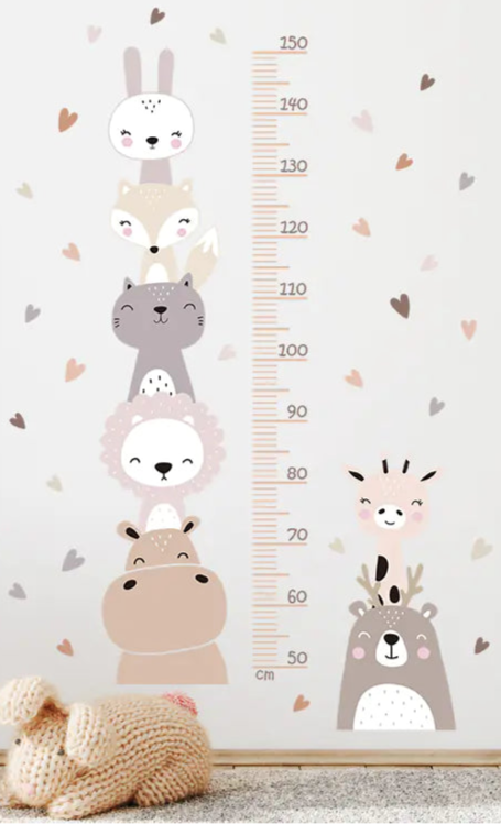 Children's room with animal-themed growth chart on the wall