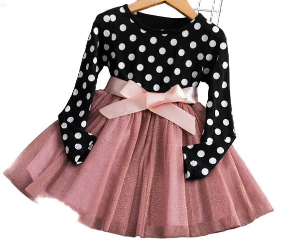 Polka dot dress with pink bow on a wooden surface